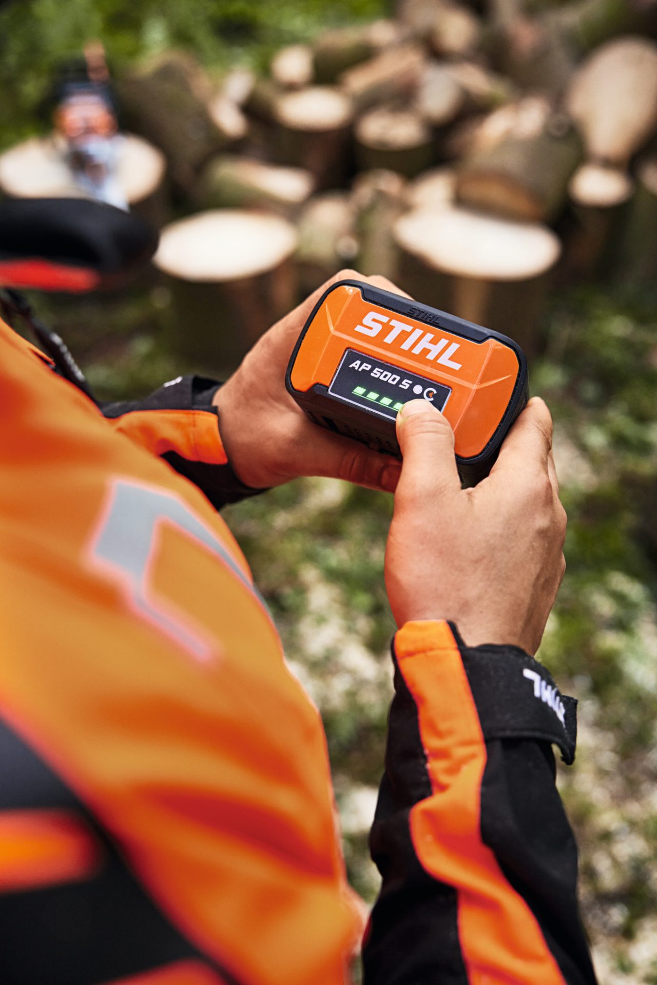 Zbliżenie na osobę trzymającą w rękach akumulator litowo-jonowy STIHL AP 500 S