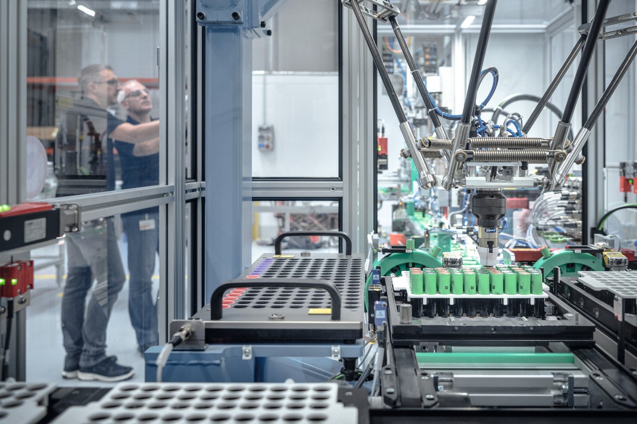 Dwóch mężczyzn produkujących akumulatory STIHL w otoczeniu maszyn i robotów